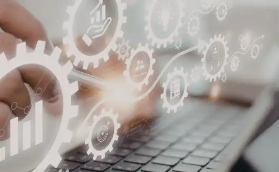Workflow automation gears over a laptop keyboard